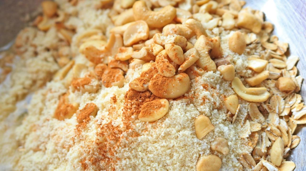 Close-up of nuts, oats, flour, and cinnamon in a bowl.